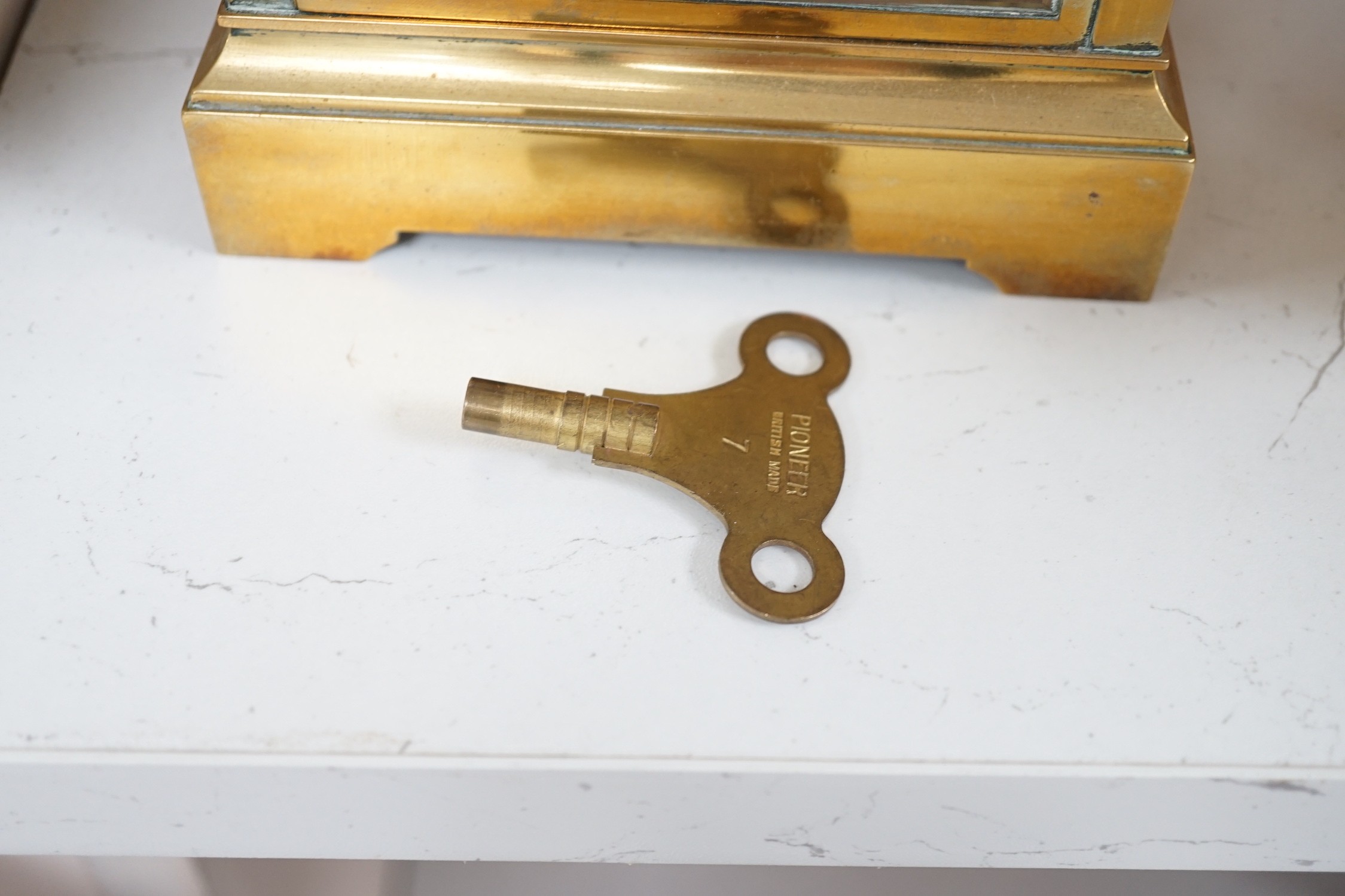 A French brass four glass mantel clock, 23cms high
